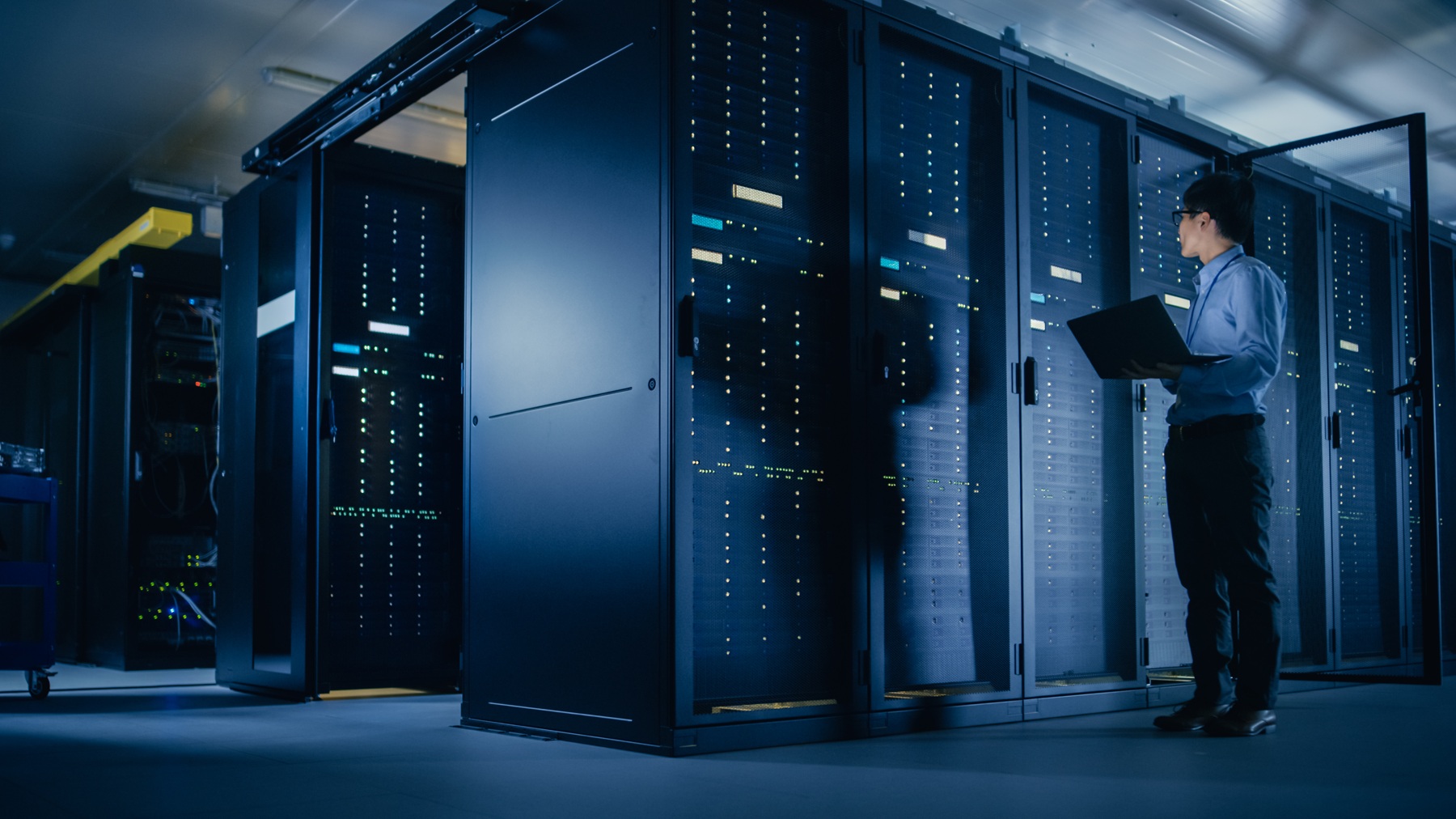 In Data Center: Male IT Technician Running Maintenance Programme