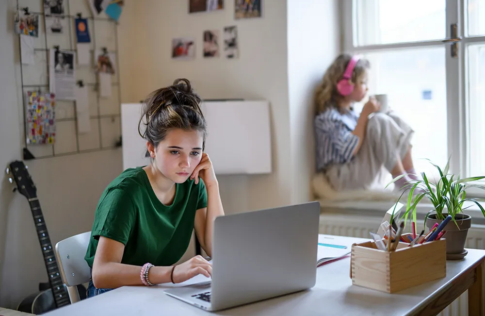 getty-images-uQgJtIo8CRc-unsplash AA student, sitting and working on a computer.