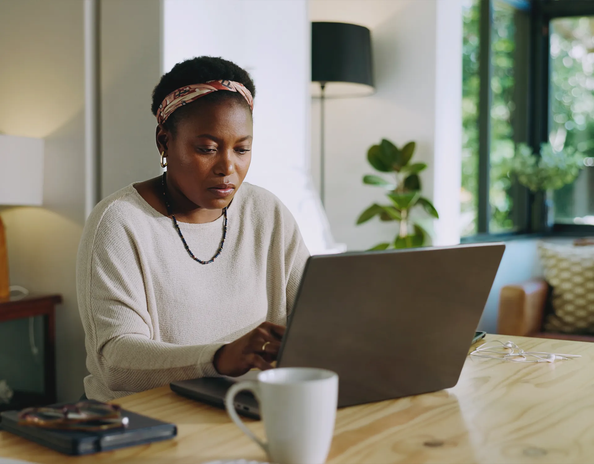 black-woman-browsing-at-home Black woman browsing on a laptop at home.