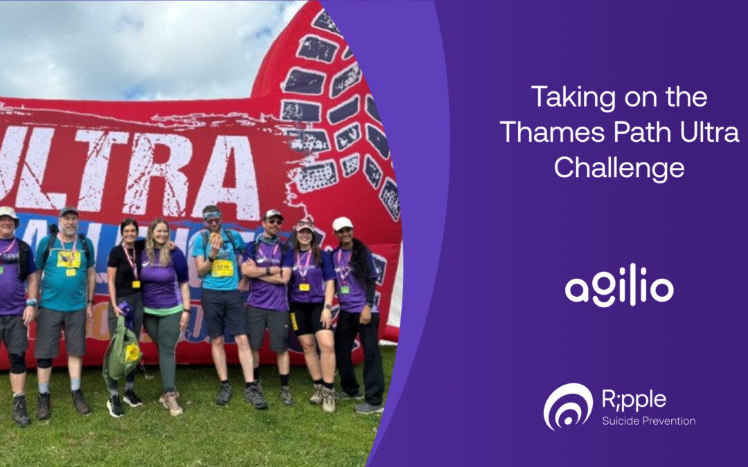 Ocho personas con camisetas de Ripple y medallas, de pie sobre el césped frente a un gran arco hinchable rojo del Ultra Challenge