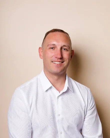 David Savage, CTO of Ripple For Business, smiling in a white shirt against a plain beige wall